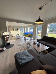 a living room with a couch and a table at Beautiful Villa in Isfjorde in Isfjorden