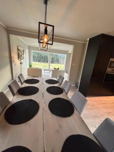 a conference room with a large wooden table and chairs at Beautiful Villa in Isfjorde in Isfjorden +24 photos