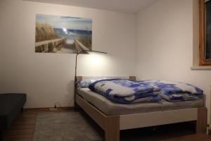 a bedroom with a bed and a painting on the wall at Haus Frei-Zambra in Vandans