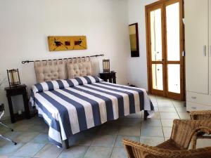 a bedroom with a bed with a striped blanket on it at Residence Orsa Minore in Gallipoli +278 photos