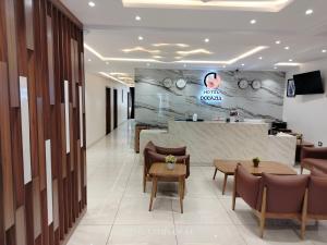 a lobby of a dental office with chairs and a table at Hotel Occazia Lubumbashi in Lubumbashi +15 photos