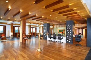 a large lobby with desks and chairs in a building at Chandys Windy Woods Munnar in Munnar