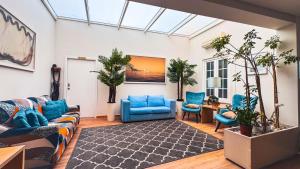 a living room with blue furniture and plants at Sea Garden Peniche in Peniche