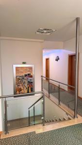 a lobby with stairs and a painting on the wall at Sea Garden Peniche in Peniche