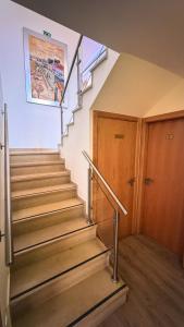 a staircase in a building with a metal hand rail at Sea Garden Peniche in Peniche