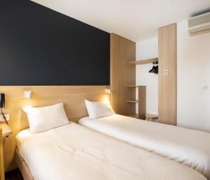 Postel nebo postele na pokoji v ubytování The Originals Access Hôtel Bordeaux Aéroport
