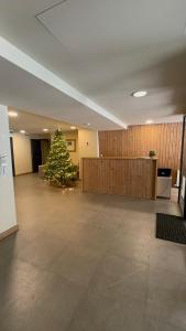 a christmas tree in the middle of a room at Bakuriani Kohta-Mitarbi Cozy studio B1 in Bakuriani