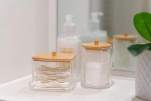 two glass containers with wooden tops sitting on a counter at Sunshine in Eastbourne