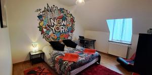 a bedroom with a large mural on the wall at Domaine de montboulon in Saint-Georges-sur-Baulche