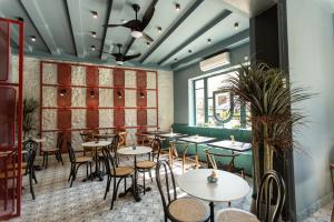 a restaurant with tables and chairs in a room at Boutique Hotel Tuta in Kutaisi