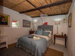a bedroom with a bed with a tray on it at Daniel's Kraal Guest Farm in Calitzdorp