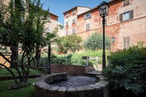 a garden with a bench and a street light at Restart Accommodations Dea Roma in Rome