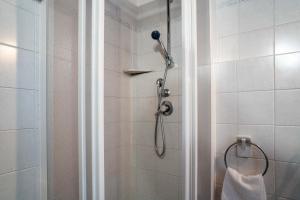 a bathroom with a shower with a shower head at La casa di Sophia - vicino alle piste da sci in Ponte di Legno