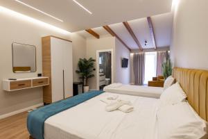 Postel nebo postele na pokoji v ubytování Golemi Lux Hotel