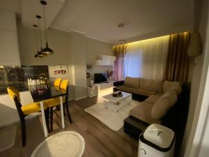 a living room with a couch and a table at 4E Apartament in Pogradec +3 photos