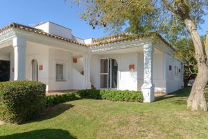 a white house with a tree in the yard at Villa Lirio in Benalup Casas Viejas