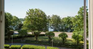 a view of a park with trees and a road at PLAZA Premium Schwerin in Schwerin