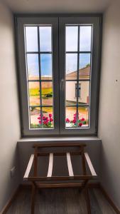 a window with a bench in a room with flowers at Sea Garden Peniche in Peniche