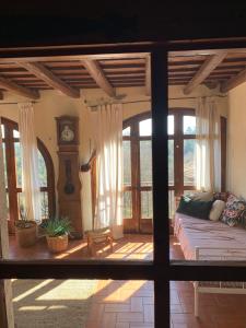 a living room with a couch and a grandfather clock at Masia Cal Millàs - Turisme Rural in Castellfullit de Riubregós +56 photos