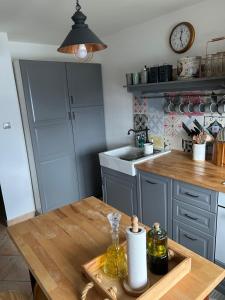 a kitchen with a wooden table and a counter top at Vacation house SMEKI in Lokošin Dol +9 photos