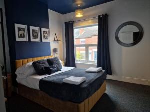 a bedroom with a bed with two towels on it at Comfortable 3 Double Bed Victorian Terrace from Luxus Stays in Spon End