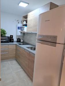 a kitchen with a refrigerator and a sink at Allende Suite Villa Allende in Villa Allende