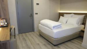 Postel nebo postele na pokoji v ubytování Optimal Hotel