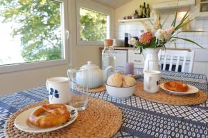 a table with two plates of donuts on it at Ferienhaus Hedwigsblick in Westerholz +17 photos