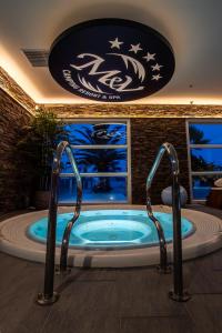 a jacuzzi tub in a room with a large sign at M&V Resort Camping in Langrune-sur-Mer