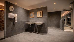 a bathroom with a sink and a shower at M&V Resort Camping in Langrune-sur-Mer