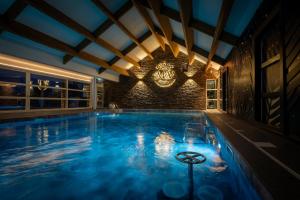 a large swimming pool in a building at M&V Resort Camping in Langrune-sur-Mer