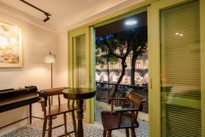 a room with a table and chairs and a window at Annam Art Hoan Kiem Lake in Hanoi
