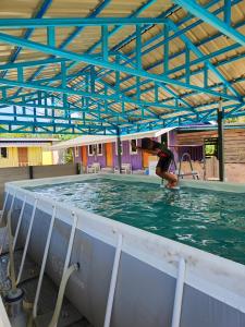 a person is in the water in a swimming pool at PS Din Kontenastay in Kota Bharu