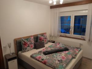 a bedroom with a bed with pillows and a window at Ferienwohnung Christina in Möllbrücke