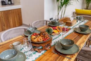 a wooden table with a plate of food on it at Exclusive Luxury Villa with Pool - Your Private Oasis Steps from the City Center! in Kerobokan
