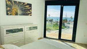 a room with a large window with a view of the ocean at Casa Paz en Benajarafe in Benajarafe +37 photos