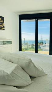 a bedroom with a bed with a view of the ocean at Casa Paz en Benajarafe in Benajarafe