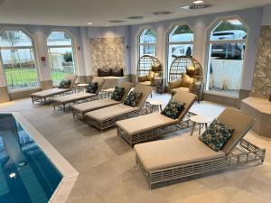a lobby with several chairs and a swimming pool at Privat-Hotel Villa Aurora in Bad Neuenahr-Ahrweiler