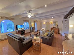 a living room with couches and a flat screen tv at VH CostaBlanca - MIRASOL in Fanadix