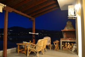 a patio with a table and chairs and a fireplace at Lakeview Balcony in Kastoria in Kastoria