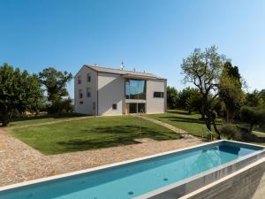 a villa with a swimming pool in front of a house at passa tempo Boutique Hideaway in Montefano