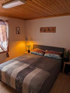 a bedroom with a large bed with a wooden ceiling at Haus Aurora in Hedenäset
