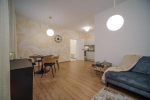 a living room with a blue couch and a table at Apartmán v srdci Prahy in Prague