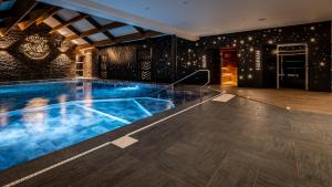 a swimming pool in a house with a ceiling at M&V Resort Camping in Langrune-sur-Mer