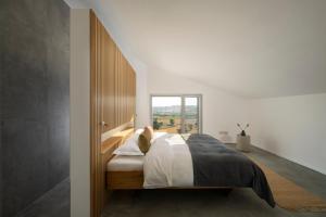 a bedroom with a bed with a large window at passa tempo Boutique Hideaway in Montefano +33 photos