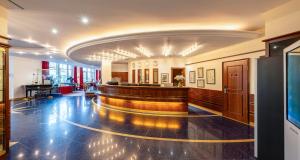 a large hall with a bar in a building at PLAZA Premium Schwerin Sure Hotel Collection by Best Western in Schwerin