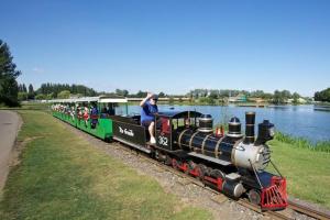 a small train with people riding on the tracks at Large double sized lodge ideal for furry friends to stay in Great Billing