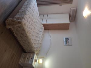 a staircase in a room with a bed and a table at House Nikola in Tučepi