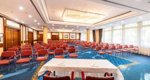 a large room with tables and chairs in it at PLAZA Premium Schwerin in Schwerin