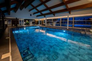 a large swimming pool with blue water at M&V Resort Camping in Langrune-sur-Mer